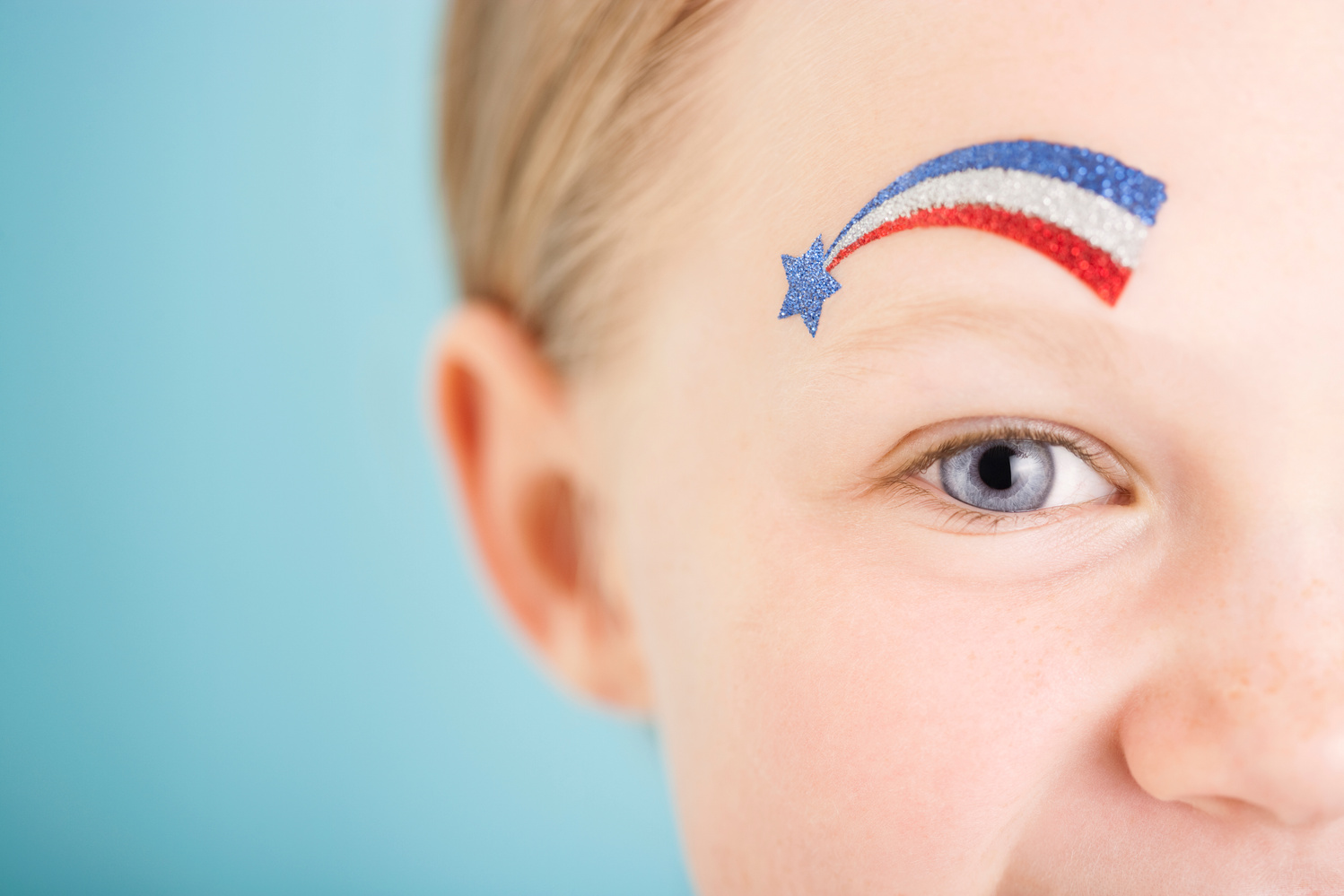 Red white and blue glitter tattoo above eye