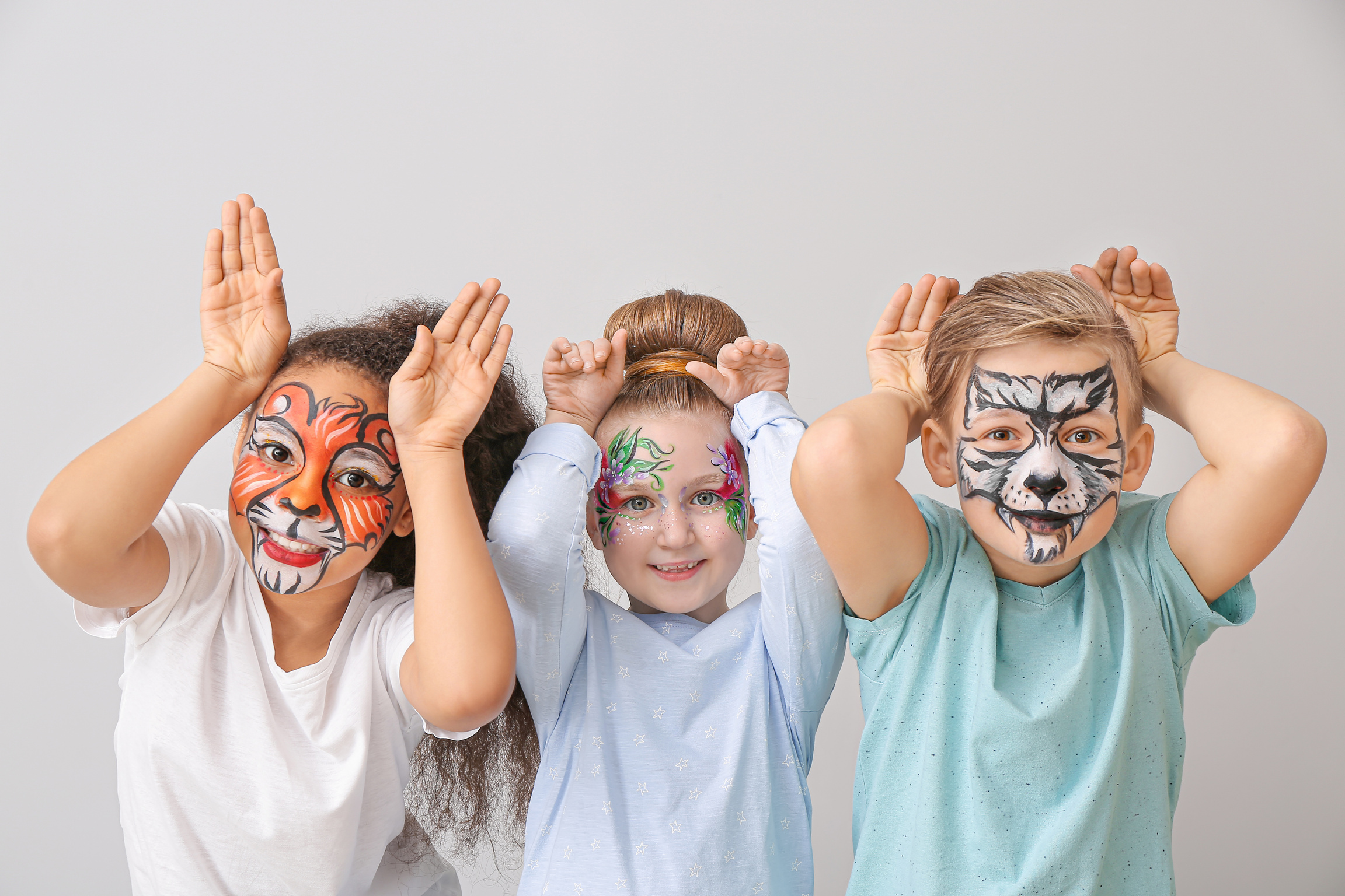 Children with Face Painting on Light Background